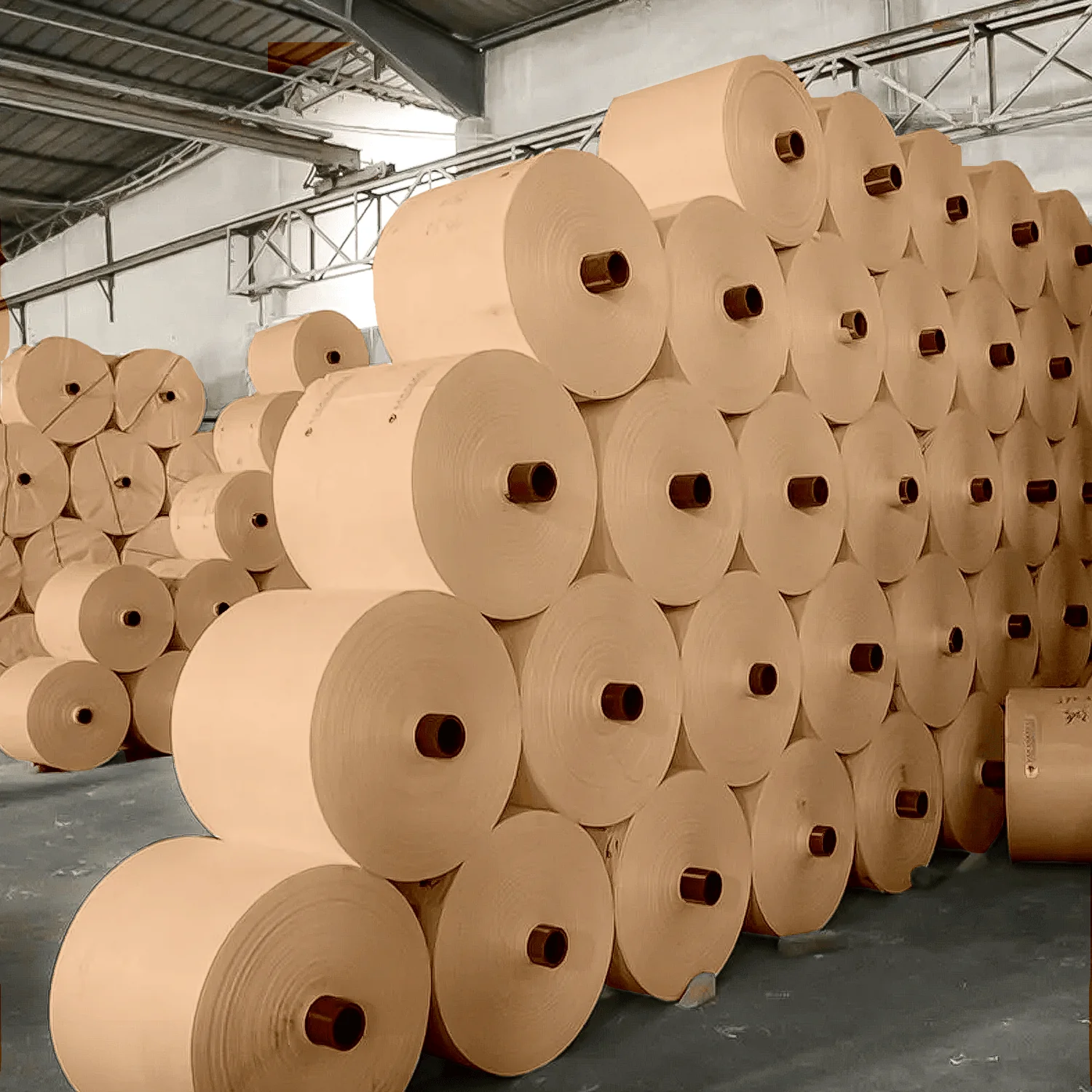 A technician inspecting a roll of kraft paper for quality assurance